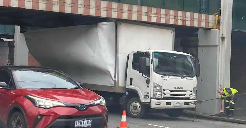 Truck trying to be towed tangled in twisted cables and tires tiredly turning